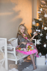 Girl near Christmas tree with presents and toys, boxes, Christmas, New Year, lifestyle, holiday, vacation, waiting for santa