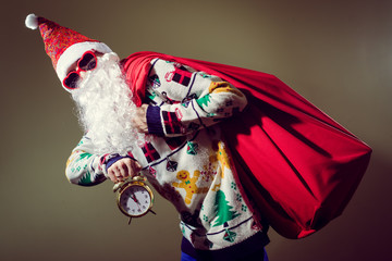 Funky Santa Claus with alarm clock wearing heart shape sunglasses
