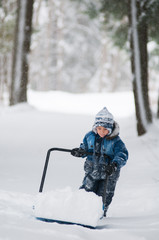 Fototapeta na wymiar young boy shoveling snow during a winter snow storm