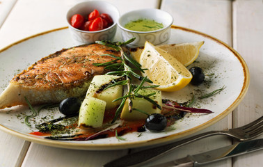 Grilled salmon on a plate with sauce and spices