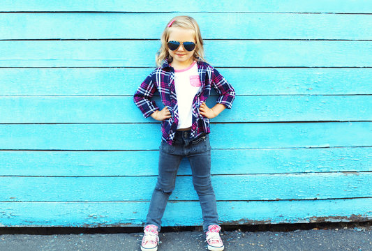 Fashion Kid In City, Stylish Child Wearing A Sunglasses And Chec