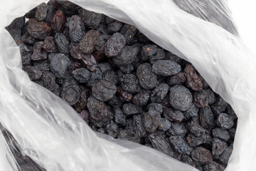 Black raisins in a plastic bag