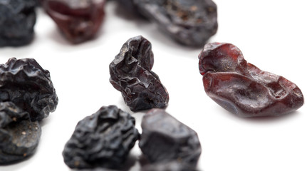 Black raisins on a white background. macro