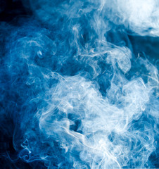 Obraz na płótnie Canvas blue smoke on a black background