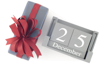Christmas Vintage Wood Calendar with a festive present gift isolated on white background. Save the Date for Christmas day.