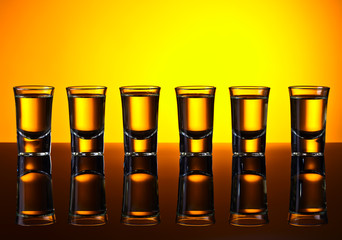 Gold tequila on a black reflective background