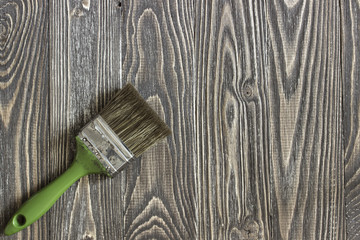 Paintbrush lying on a wooden table. Background top view