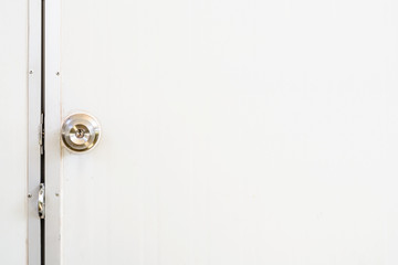 Metallic of door knob on white door