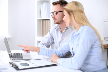 Two successful business partners working at meeting in office