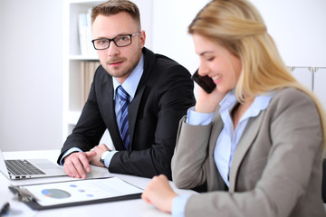 Two successful business partners working at meeting in office