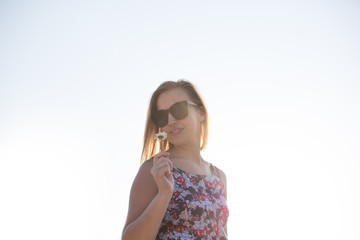 Happy woman jumping field against blue sky. Summer vacation conc