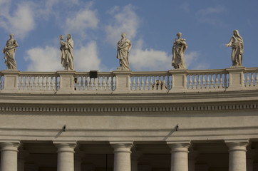 Fototapeta na wymiar Architectural close up of the colonnade in Saint Peters Square in Vatican City, with statues on the terrace