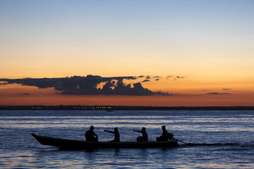 Sunset and silhouettes on boat cruising the Amazon River, Brazil