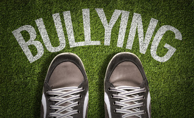 Top View of Sneakers on the grass with the text: Bullying