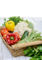  basket of seasonal vegetables on  wooden table