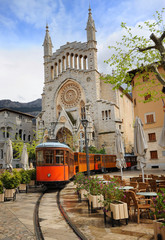 Old tram in front of the Cathedral of Soller, Mallorca, Spain - obrazy, fototapety, plakaty