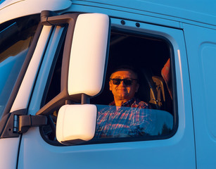 Driver in the cabin of him truck