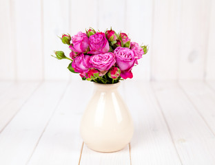 fresh flowers roses on white wooden background