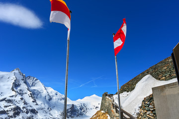Flags hoover in the wind at the snow mountain background
