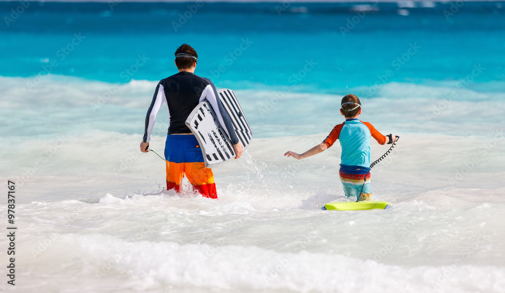 Poster father and son surfing