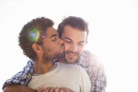 Young man kissing his partner outdoors
