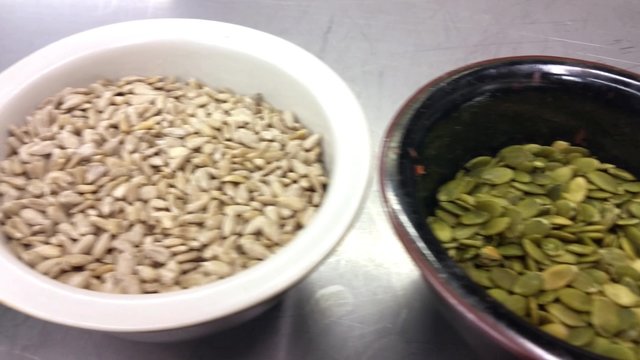 Sunflower-, pumpkin- and linseed seeds, in porslin bowls, at a restaurant kitchen