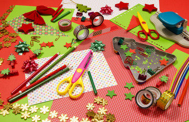 Arts and craft supplies for Christmas. Red and green color paper, pencils, different washi tapes, craft scissors, festive Xmas supplies for decoration. - 97839522
