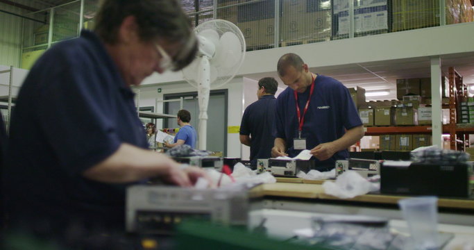 Workers building computers in a British electronics factory