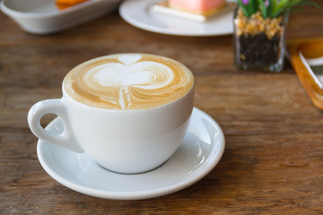 Close up cup of Coffee, latte on the wooden table
