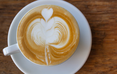 Close up cup of Coffee, latte on the wooden table
