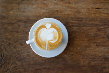 Close up cup of Coffee, latte on the wooden table
