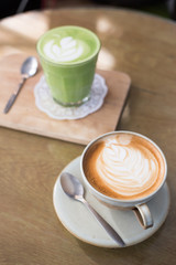 Hot drinks with latte coffee matcha green tea on wooden table