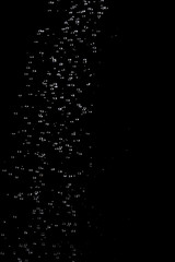 Abstract splashes and drops of water on black background.