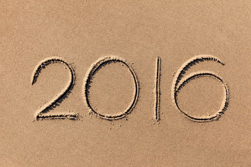 2016 year written on the beach sand
