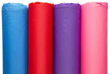 Colorful material fabric rolls on white background