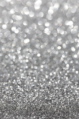 Silver sparkle. Glitter background. Holiday blurred background.