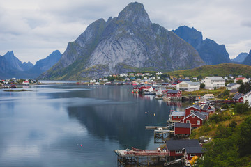 Beautiful super wide-angle summer aerial view of Reine, Norway, Lofoten Islands, with skyline, mountains, famous fishing village with red fishing cabins, Moskenesoya, Nordland © tsuguliev