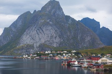 Fototapeta na wymiar Beautiful super wide-angle summer aerial view of Reine, Norway, Lofoten Islands, with skyline, mountains, famous fishing village with red fishing cabins, Moskenesoya, Nordland