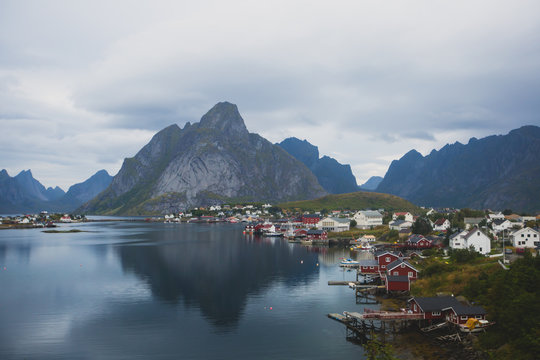Beautiful super wide-angle summer aerial view of Reine, Norway, Lofoten Islands, with skyline, mountains, famous fishing village with red fishing cabins, Moskenesoya, Nordland