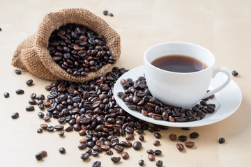 Cup of coffee and fresh roasted organic Coffee beans on isolated background, food and drink background