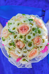 Wedding bouquet in hands of bride