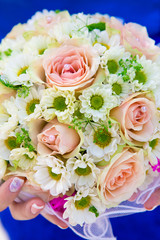 Wedding bouquet in hands of bride