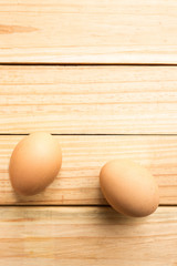 hen eggs in bowl on wood plate