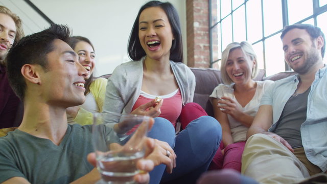 Group of attractive multi ethnic friends relaxing and chatting together