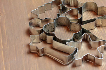 gingerbread cookie cutters on wooden background