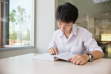 Asian student in library