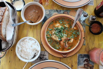Delicious Brazilian seafood stew with garlic rice and elderflower paste