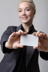 Businesswoman holding a blank card