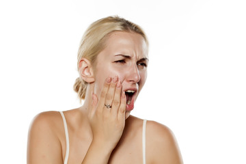 young blonde has a severe toothache