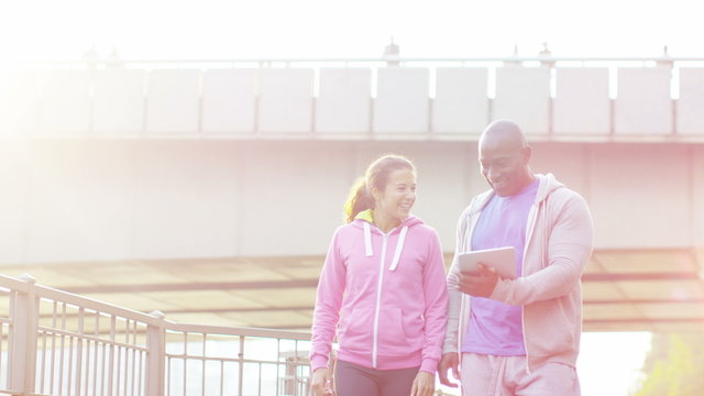  Personal trainer high fives his female client to celebrate her improvement